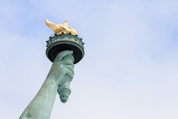 Close up of torch of the Statue of Liberty in New York City. This is the copper statue which is a gift from the people of France to the people of the United States. It’s a famous attraction in US.