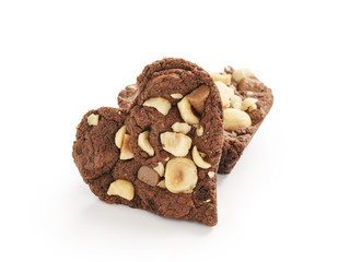 homemade heart shaped chocolate cookies with hazelnuts and chocolate pieces isolated on white