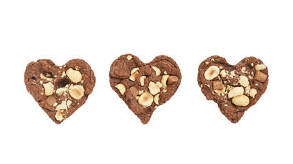 homemade heart shaped chocolate cookies with hazelnuts and chocolate pieces isolated on white