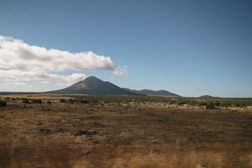 Driving plate side view moving through desert in car with motion blur