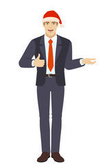 Businessman in Santa hat gesticulating and showing thumb up