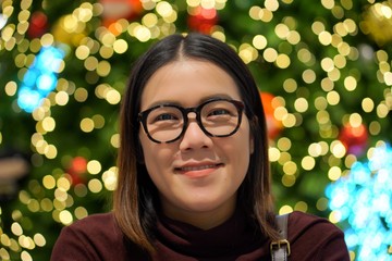 asian woman smiling and posting with bokeh lighting 