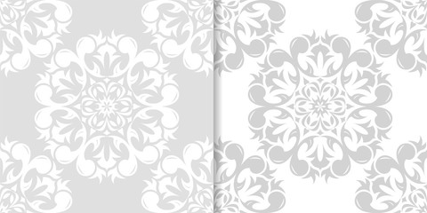 Light gray floral backgrounds. Set of seamless patterns