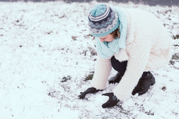 Smiling young woman in snowing outdoor.