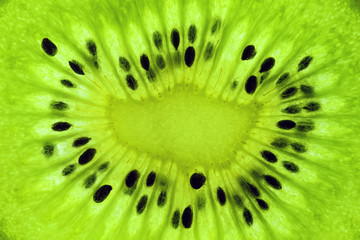 macro top view of a actinidia kiwi fruit slice texture, backlight