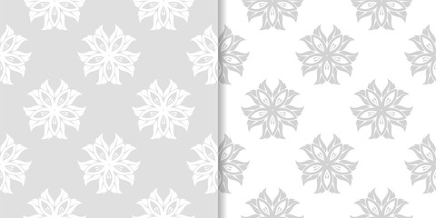 Light gray floral backgrounds. Set of seamless patterns