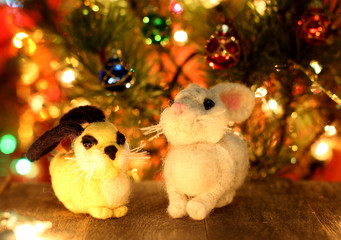 Symbol of new years 2018 white husky dog. Bolt. New years greetings background. Fancy handmade toy from wool on bokeh Christmas background. Copyspace for congratulations.