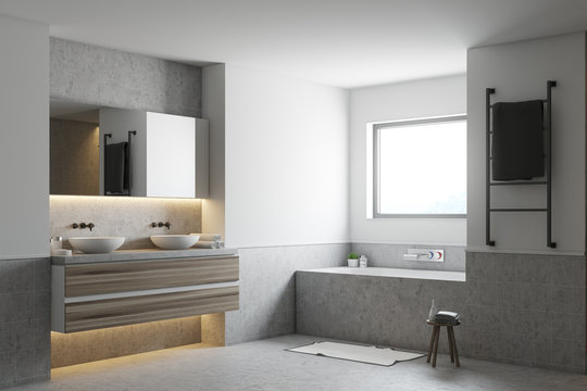 White bathroom corner, gray tub and sinks