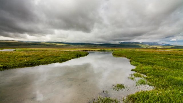 Dramatic sky over mountain river. Timelapse