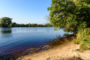 high water level in river Gauja, near Valmiera city in Latvia. summer trees surrounding