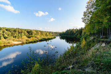 Fototapeta premium high water level in river Gauja, near Valmiera city in Latvia. summer trees surrounding