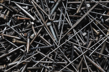 Background of bunch of old nuts bolts and nails