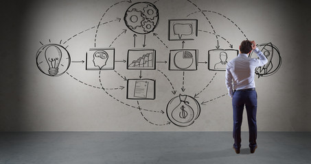Businessman watching a project sketch on a wall 3D rendering