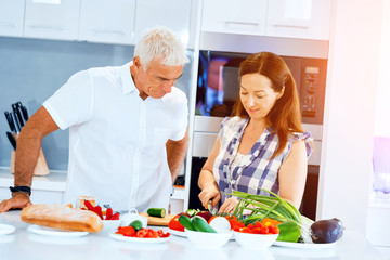 Mature couple cooking at home