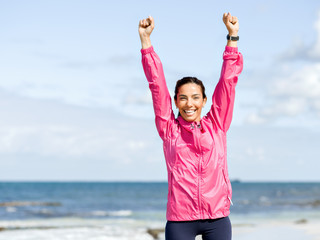 Athletic woman in sportswear standing at the seaside