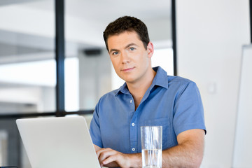 Handsome businessman working at computer