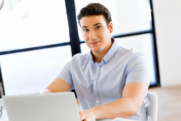 Handsome businessman working at computer