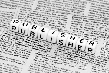 Fototapeta premium Publisher alphabet cubes on newspaper