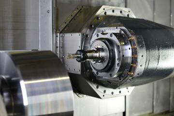 The 5-axis CNC machine while cutting the sample part of turbine.The spindle of 5 axis CNC machining...