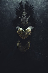Horror, dark gothic dress formed by a silver metal tiara and a golden corset, handmade costume