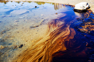 Texture of crude oil spill, pools of crude oil floating on the surface of Saronic Gulf waters in...