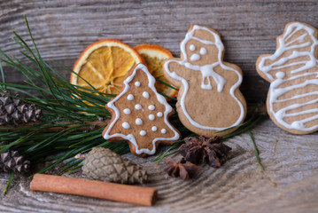 curly ginger cookies on the table and the branches of the pine