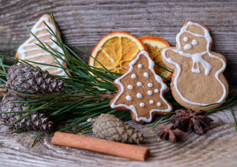 curly ginger cookies on the table and the branches of the pine