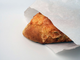 Cheese bread, packed in a paper bag, isolated on white