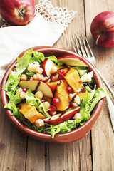 Salad with apple ,pumpkin and melogran on rustik background.