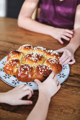 Obraz na płótnie Canvas Swiss sweet bread with a golden paper crown and hidden miniature of king baked traditionally in Switzerland for Three Kings Day on January 6