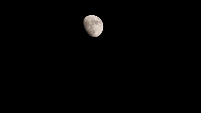 Moon time lapse moving across night sky. 4K