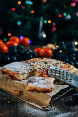 cheese cake with chocolate, biscuits, tangerines, grapes on a wooden table