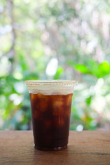 Iced coffee on table in garden cafe
