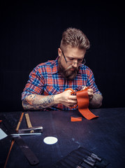 Leather Artist processing a leather workpiece in the work area