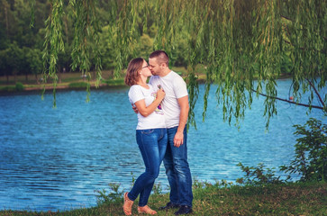Loving young couple on background of the river.
