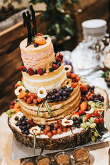 Naked cake served on a wooden plate for wedding party