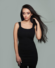 Perfect Young Woman Fashion Model with Long Healthy Blowing Hair. Beauty Salon Background