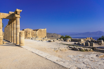 Columns of Portico and Church of St. John on the Acropolis of Lindos (Rhodes, Greece)