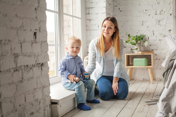 Mother and Son Playing at Home. Woman and Child Wearing Blue Denim Cloth
