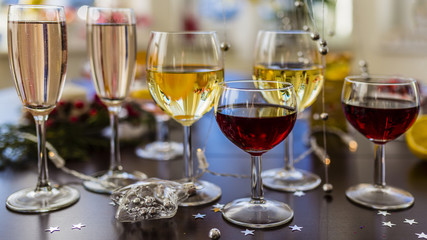 New Year's party. White and red wins and drinks in glasses.
