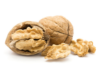 Walnuts isolated on white background one unshelled one open half and two shelled nut halves.