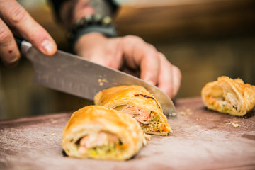 The chef in the kitchen prepares  food with.