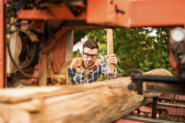 Young working man at sawmill