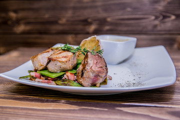 Food on a plate, on a wooden background.Food detail