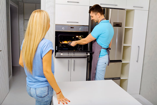 A couple is preparing a capkake in the kitchen together.