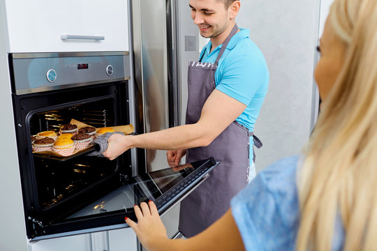 A couple is preparing a capkake in the kitchen together.