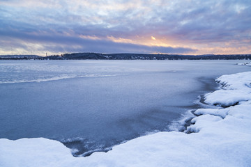 Beautiful blue moment next to lake in winter landscape from Finland