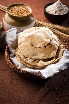 indian bread / Chapati / Fulka / Gehu Roti with wheat grains in background. It's a Healthy fiber rich traditional North/South Indian food, selective focus
