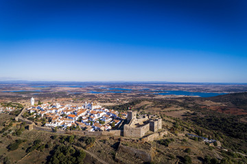 Aerial view of the historic village of Monsaraz in Alentejo with the Alqueva dam reservoir on the background  Concept for travel in Portugal and Alentejo and most beautiful places in Portugal © Tiago Fernandez