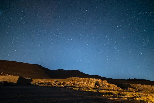 Outstanding starry sky at high altitude on the barren highlands of the Andes in Bolivia. Football ground (soccer field) in the middle of nowhere. Winter season.